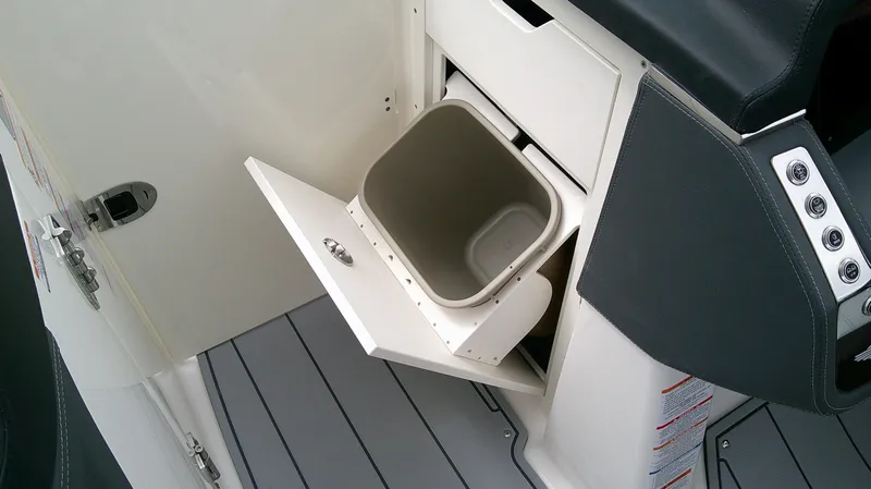 Slide: The Image of Chaparral GTS 28 2026 boat trash compartment in cabin. - 22