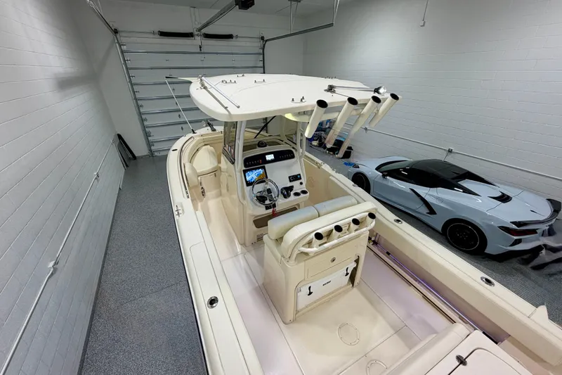 Slide: The Image of 2023 Grady-White Fisherman 257 boat in garage with sports car nearby. - 15