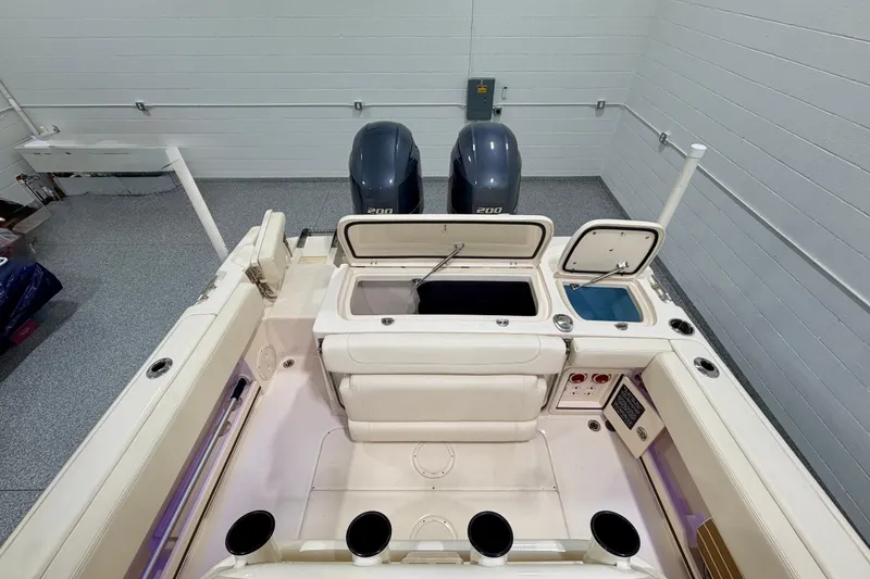 Slide: The Image of 2023 Grady-White Fisherman 257 boat interior with dual engines and storage compartments. - 17