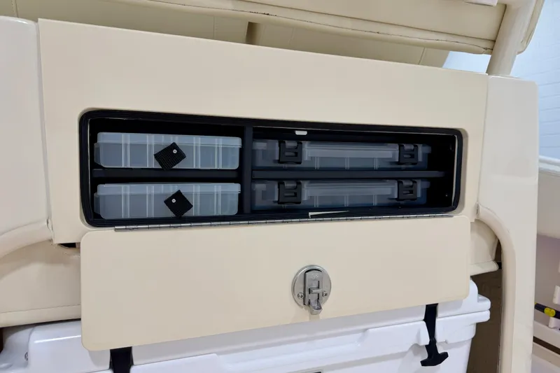 Slide: The Image of Storage compartment on 2023 Grady-White Fisherman 257 boat, featuring organized tackle boxes. - 19
