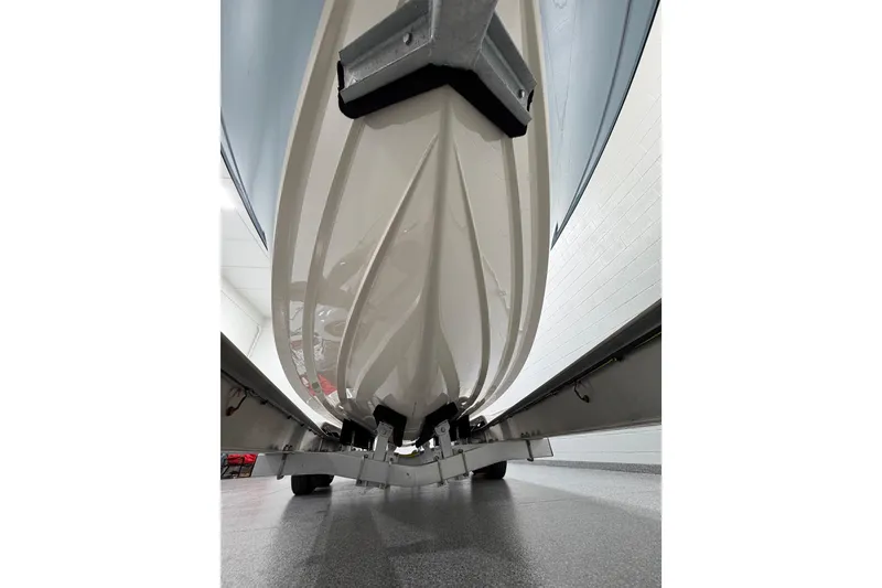 Slide: The Image of 2023 Grady-White Fisherman 257 boat hull on trailer in showroom. - 33