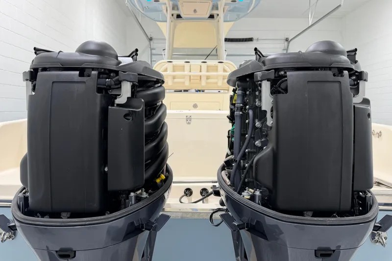 Slide: The Image of 2023 Grady-White Fisherman 257 boat with dual outboard engines in a garage. - 36