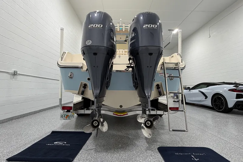Slide: The Image of 2023 Grady-White Fisherman 257 boat with dual Yamaha 200 engines in a garage. - 6