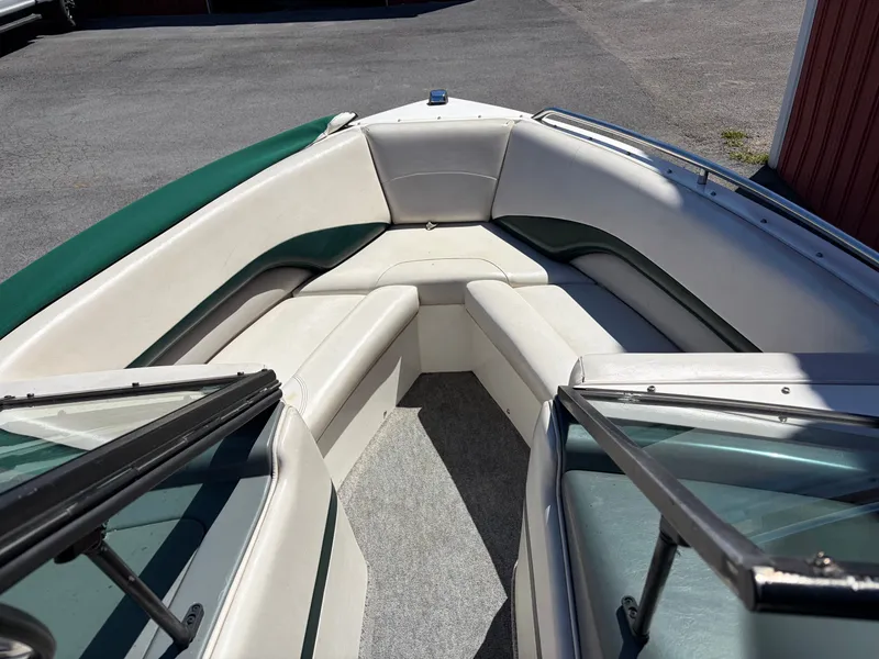 Slide: The Image of Interior of a 1997 MasterCraft Prostar 205 boat with green and white seating. - 10