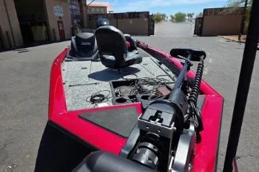 Slide: The Image of 2025 Tracker Pro Team 175 boat with red exterior, parked outdoors. - 4