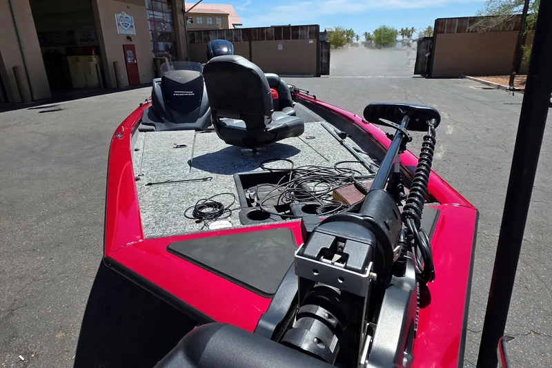 Slide: The Image of 2025 Tracker Pro Team 175 boat with red exterior, parked outdoors, featuring fishing equipment. - 8
