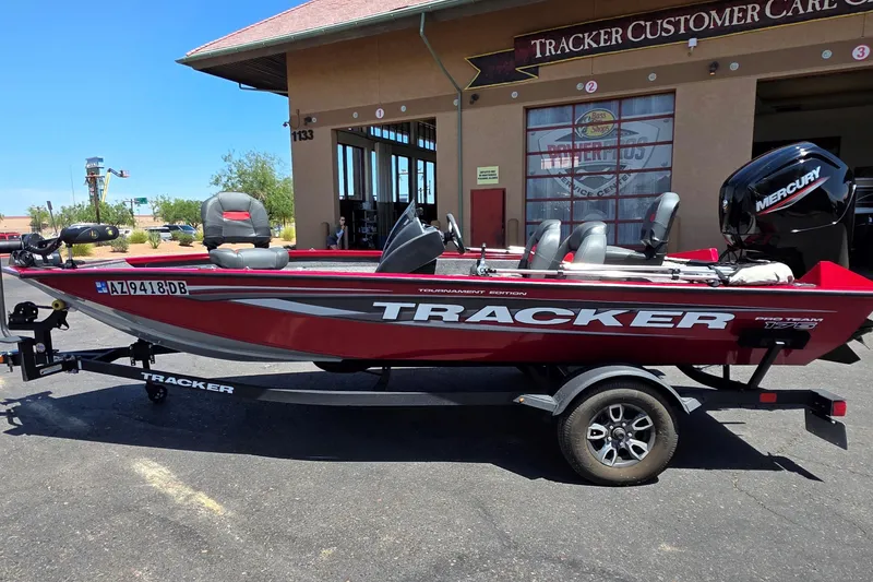 Slide: The Image of 2025 Tracker Pro Team 175 boat with Mercury engine, parked outside Tracker Customer Care. - 10