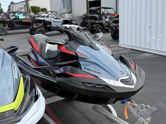 The Image of 2026 Kawasaki Ultra 160 jet ski on a trailer outdoors. - 1