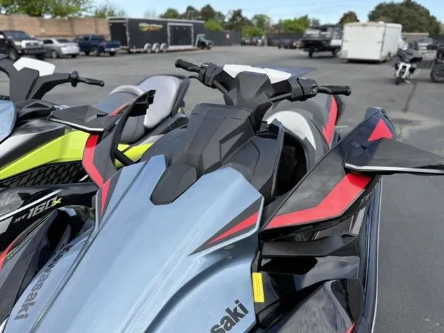 Slide: The Image of 2026 Kawasaki Ultra 160 jet ski in a parking lot. - 11