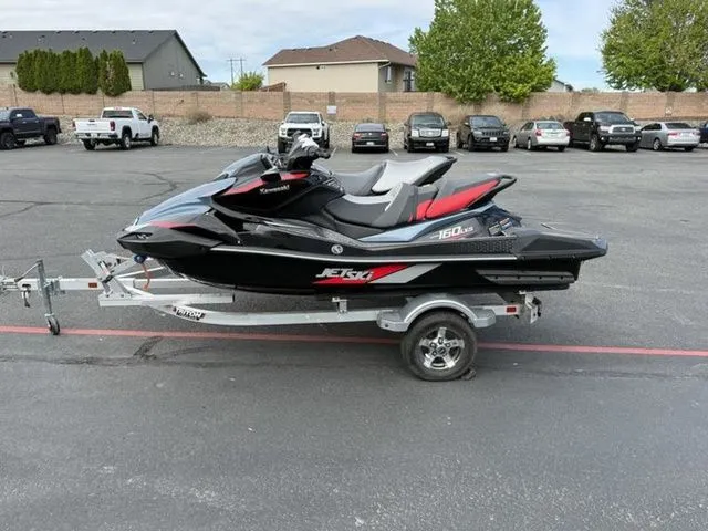 Slide: The Image of 2026 Kawasaki Ultra 160 Jetski parked on trailer outdoors. - 3