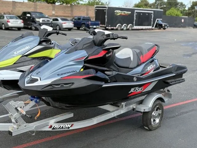 Slide: The Image of 2026 Kawasaki Ultra 160 Jetski parked on trailer outdoors. - 8