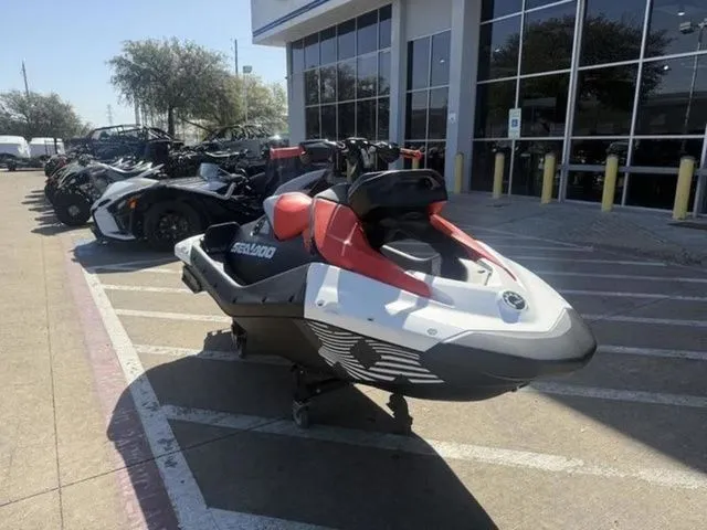 The Image of 2026 Sea-Doo SPARK TRIXX 90 jet ski parked outside a store. - 1