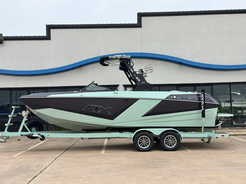The Image of 2026 ATX Surf Boats 22 Type-S on trailer in front of building. - 1