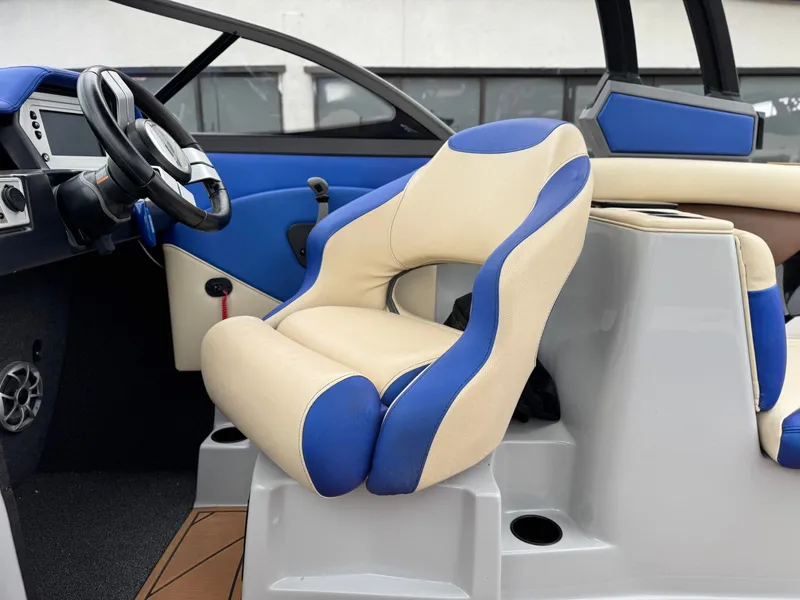 Slide: The Image of Interior of a 2018 Tigé R23 boat with blue and beige seats. - 13