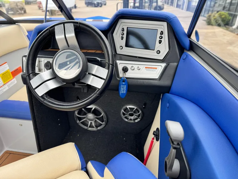 Slide: The Image of Interior of a 2018 Tigé R23 boat with blue upholstery. - 14