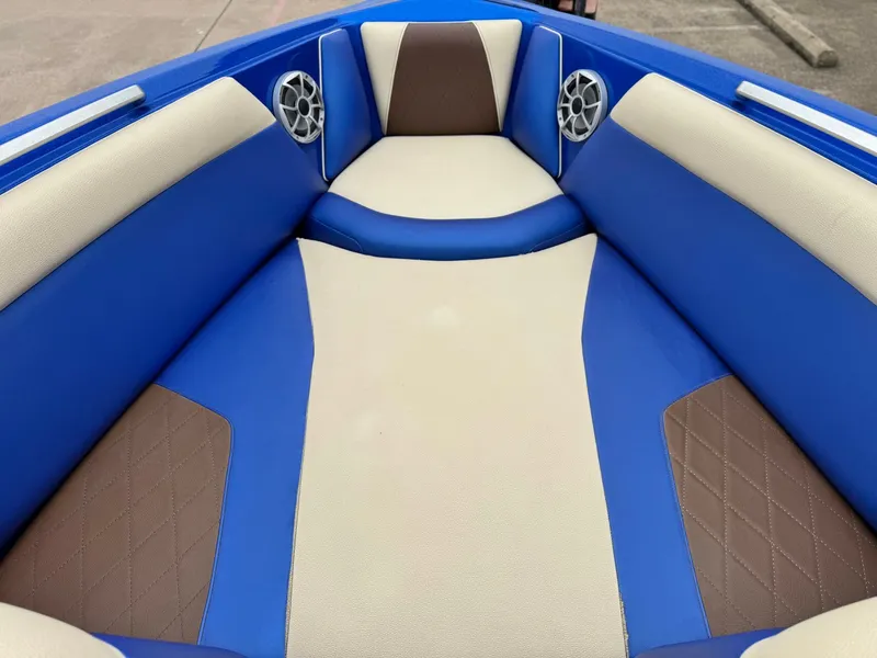 Slide: The Image of Interior of a 2018 Tigé R23 boat with blue and brown upholstery. - 15