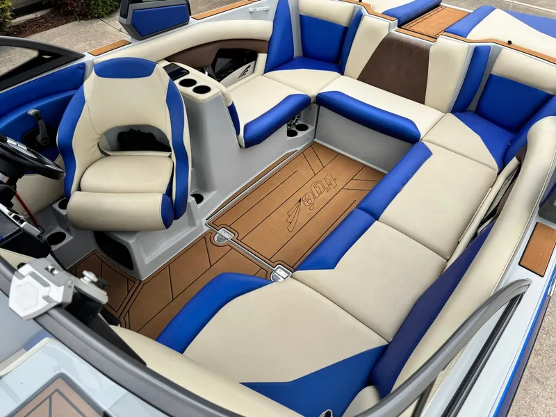 Slide: The Image of Interior of a 2018 Tigé R23 boat with blue and beige seating. - 17