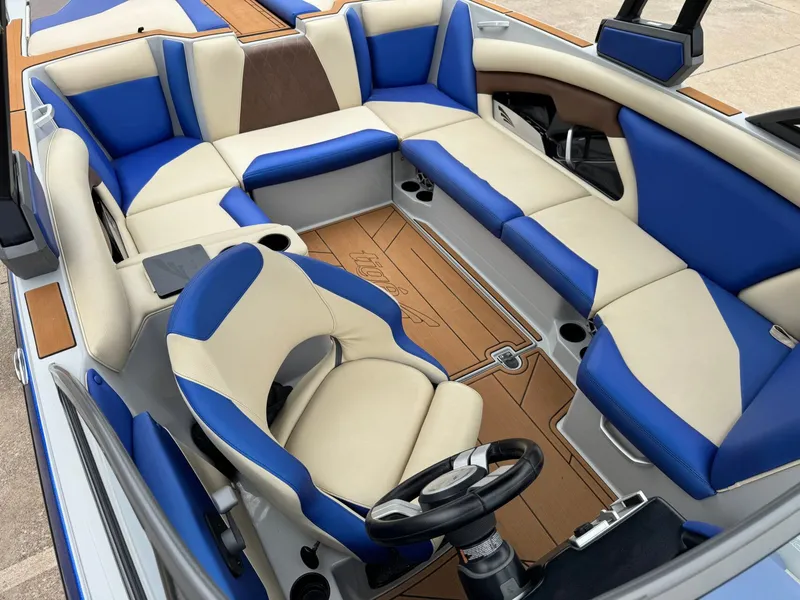Slide: The Image of Interior of a 2018 Tigé R23 boat with blue and beige seating. - 18