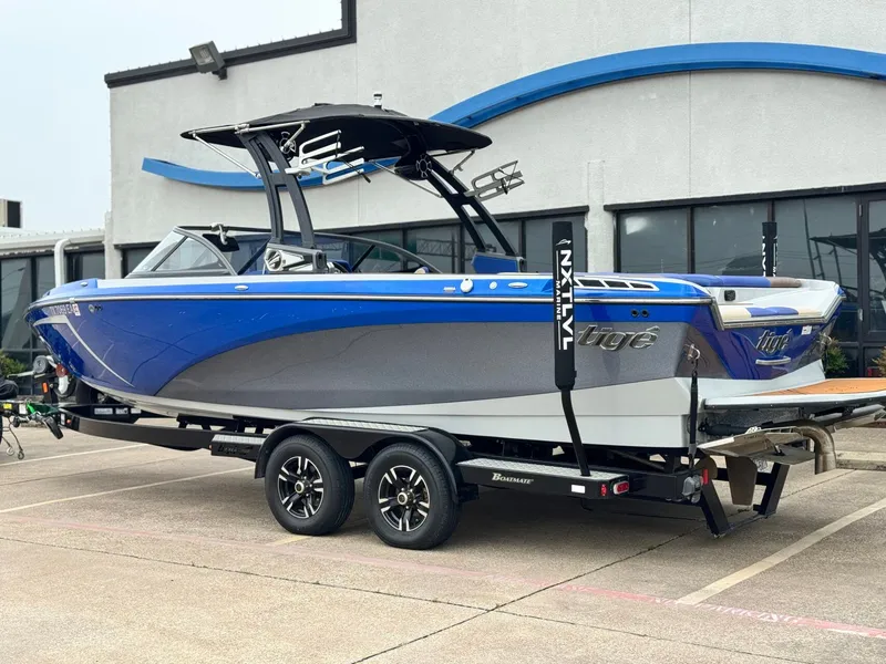 Slide: The Image of 2018 Tigé R23 boat on trailer, blue and gray, side view. - 3