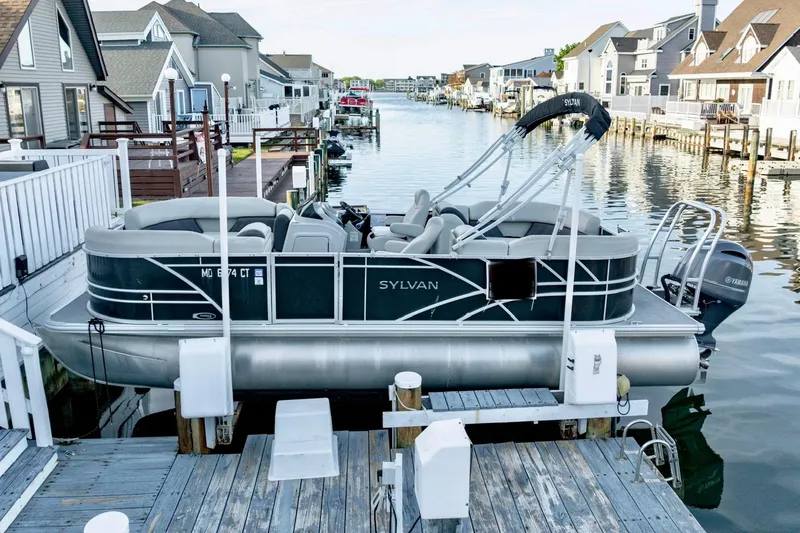 Slide: The Image of 2020 Sylvan Mirage 8522 Cruise pontoon boat docked by waterfront homes. - 11