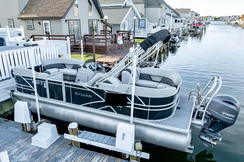 Slide: The Image of 2020 Sylvan Mirage 8522 Cruise pontoon boat docked by waterfront homes. - 12