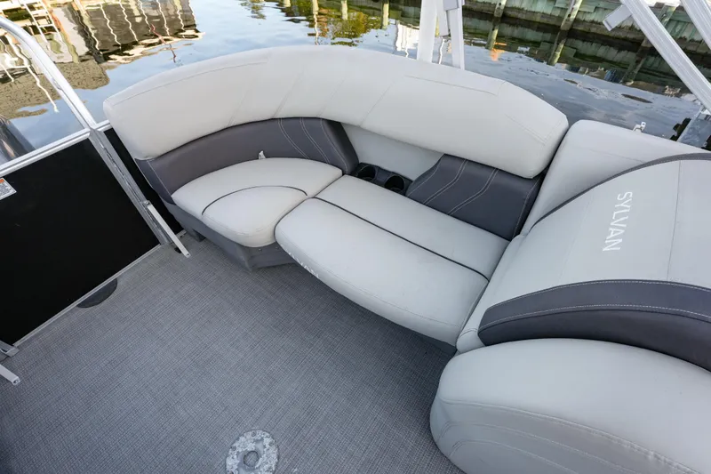 Slide: The Image of 2020 Sylvan Mirage 8522 Cruise boat interior with plush seating and cup holders. - 8