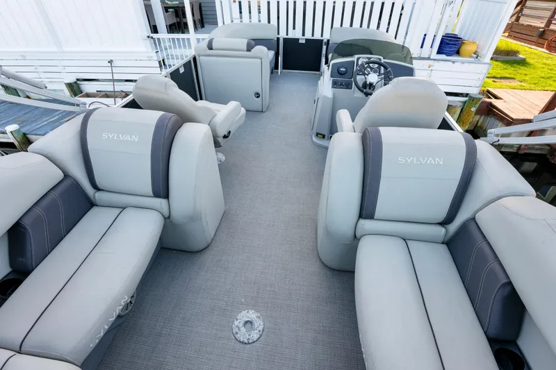Slide: The Image of 2020 Sylvan Mirage 8522 Cruise pontoon boat interior with plush seating and steering console. - 9