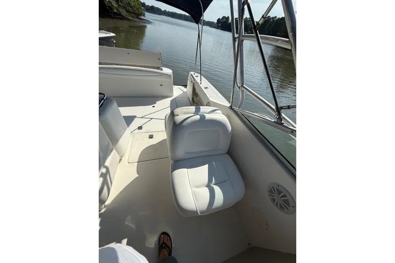 Slide: The Image of 2005 Sea Ray 290 Amberjack boat interior with white seating and water view. - 11