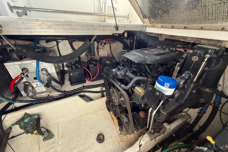 Slide: The Image of Engine compartment of a 2005 Sea Ray 290 Amberjack boat, showcasing mechanical components. - 12