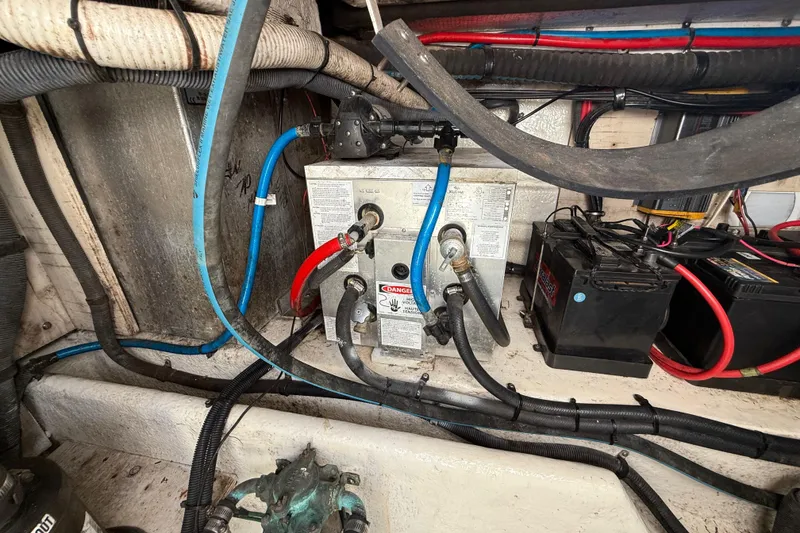 Slide: The Image of Engine compartment of a 2005 Sea Ray 290 Amberjack with wiring and battery connections. - 15