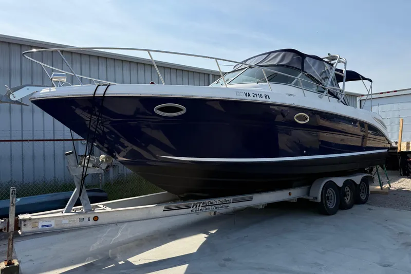 Slide: The Image of 2005 Sea Ray 290 Amberjack boat on trailer, parked outdoors. - 3