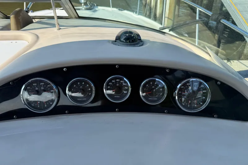 Slide: The Image of Dashboard of a 2005 Sea Ray 290 Amberjack boat with gauges and compass. - 8