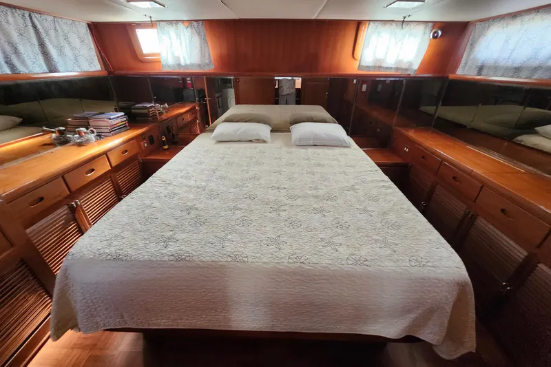 Slide: The Image of Luxurious cabin interior of 1988 Marine Trader 43 yacht with cozy bed and wooden furnishings. - 11