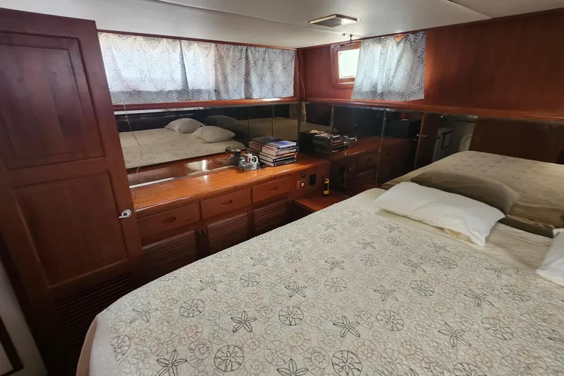 Slide: The Image of Luxurious cabin interior of 1988 Marine Trader 43 yacht with elegant wood finish. - 13