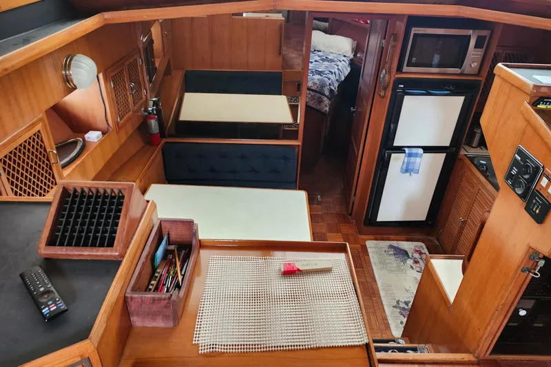 Slide: The Image of Interior of 1988 Marine Trader 43 yacht with kitchen, dining area, and cozy cabin. - 14