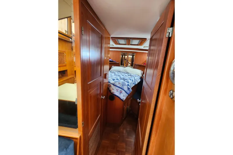 Slide: The Image of Interior cabin of 1988 Marine Trader 43 yacht with wooden finish and cozy bedding. - 15