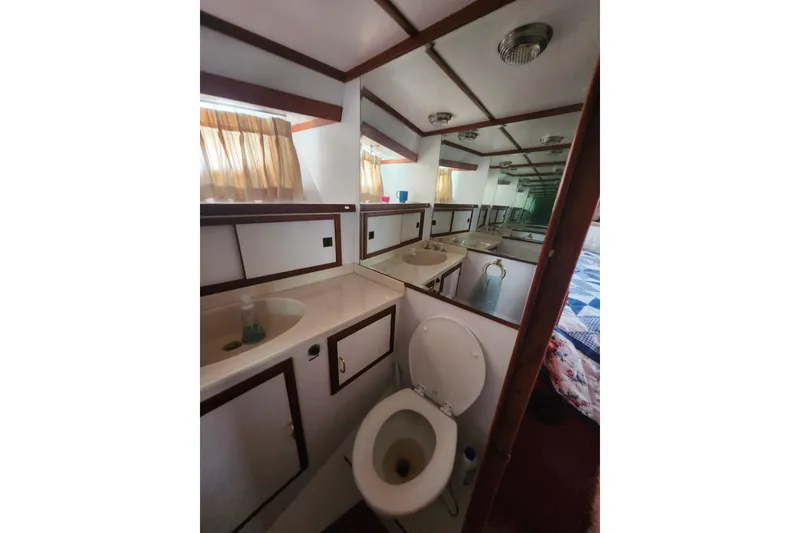 Slide: The Image of Bathroom interior of 1988 Marine Trader 43 yacht with sink, toilet, and mirror. - 17