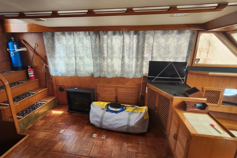 Slide: The Image of Interior of 1988 Marine Trader 43 yacht with wood paneling and nautical equipment. - 18