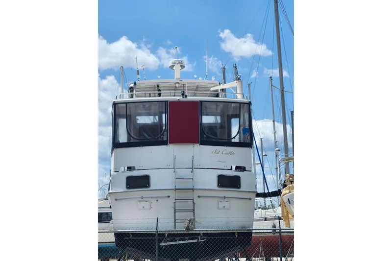 Slide: The Image of 1988 Marine Trader 43 yacht on dry dock under a clear blue sky. - 2