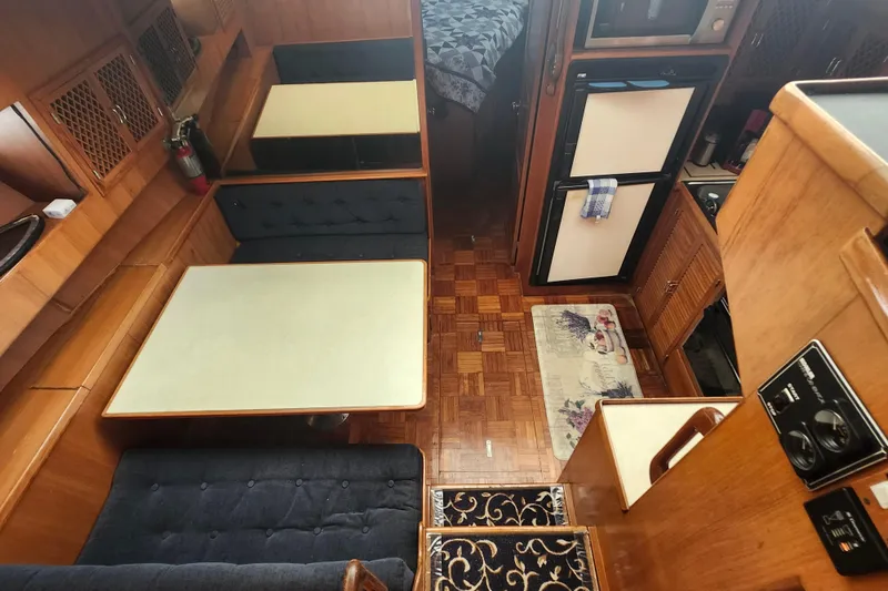 Slide: The Image of Interior of a 1988 Marine Trader 43 yacht with dining area and kitchen. - 21