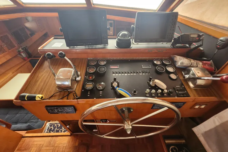 Slide: The Image of 1988 Marine Trader 43 helm with navigation equipment and steering wheel. - 22