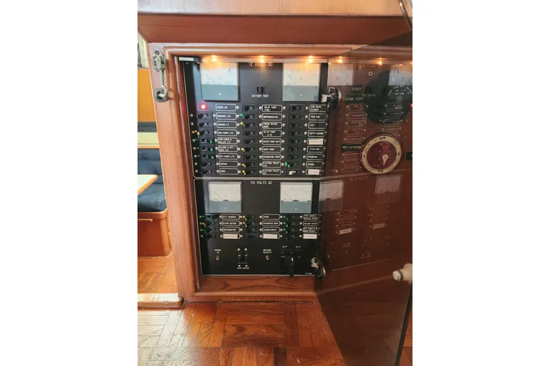 Slide: The Image of Electrical panel inside a 1988 Marine Trader 43 yacht, showcasing switches and meters. - 23
