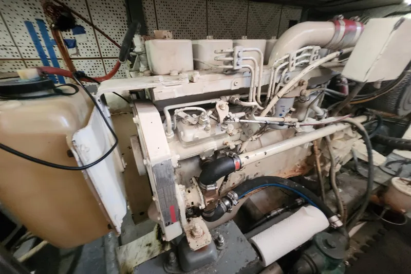 Slide: The Image of Engine room of a 1988 Marine Trader 43 boat, showcasing detailed machinery components. - 26