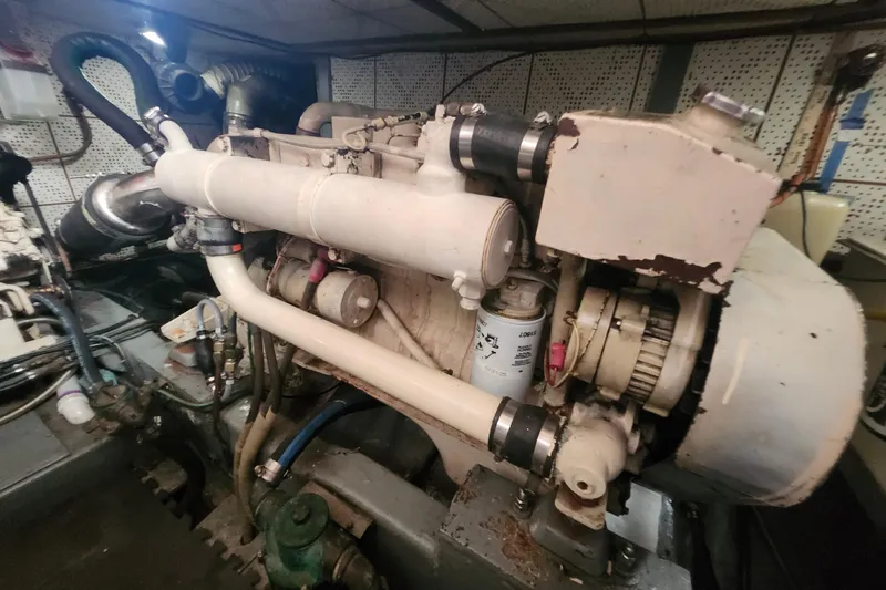 Slide: The Image of Engine room of a 1988 Marine Trader 43 boat, showcasing mechanical components. - 27