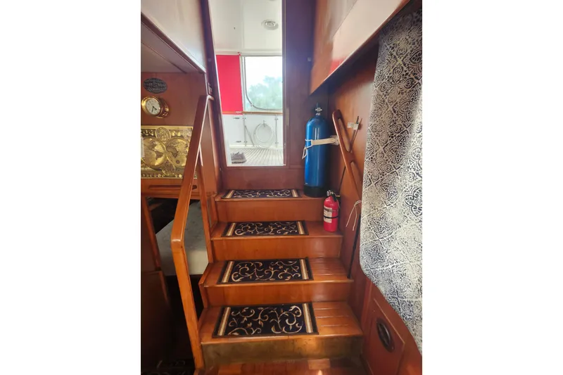 Slide: The Image of Interior stairs of 1988 Marine Trader 43 yacht with decorative carpet and safety equipment. - 31