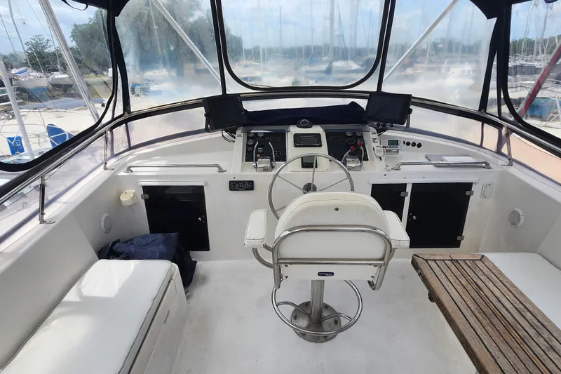 Slide: The Image of 1988 Marine Trader 43 cockpit with steering wheel, navigation equipment, and seating area. - 36