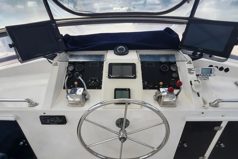 Slide: The Image of Cockpit of 1988 Marine Trader 43 yacht with navigation instruments and steering wheel. - 37