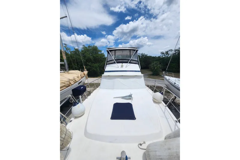 Slide: The Image of 1988 Marine Trader 43 yacht on land, under a partly cloudy sky. - 39