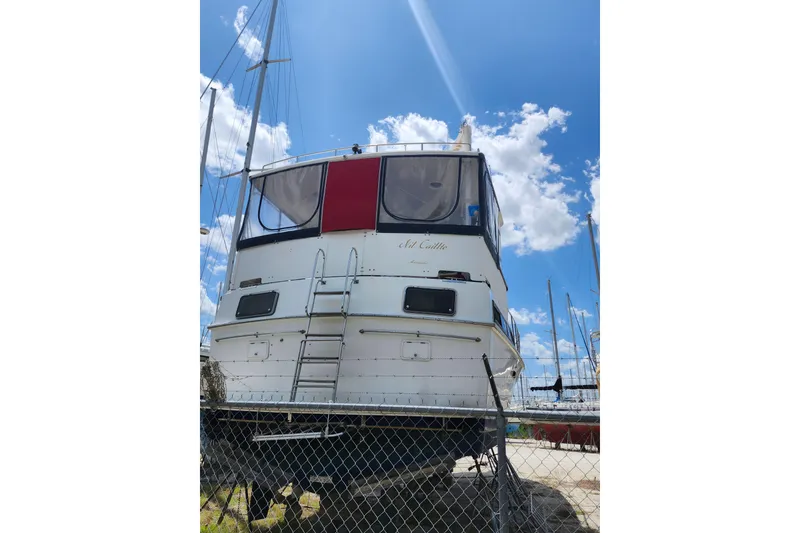 Slide: The Image of 1988 Marine Trader 43 yacht on dry dock under a clear blue sky. - 44