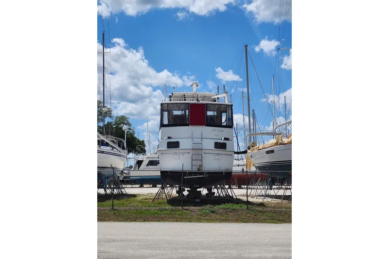 Slide: The Image of 1988 Marine Trader 43 yacht on dry dock under a bright blue sky. - 46